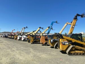 a group of yellow and black construction vehicles
